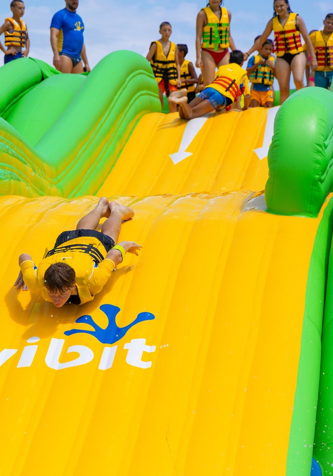 Families on the inflatable water park in Crots