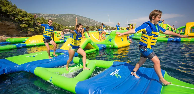 Children and adults on the inflatable Aquapark structures